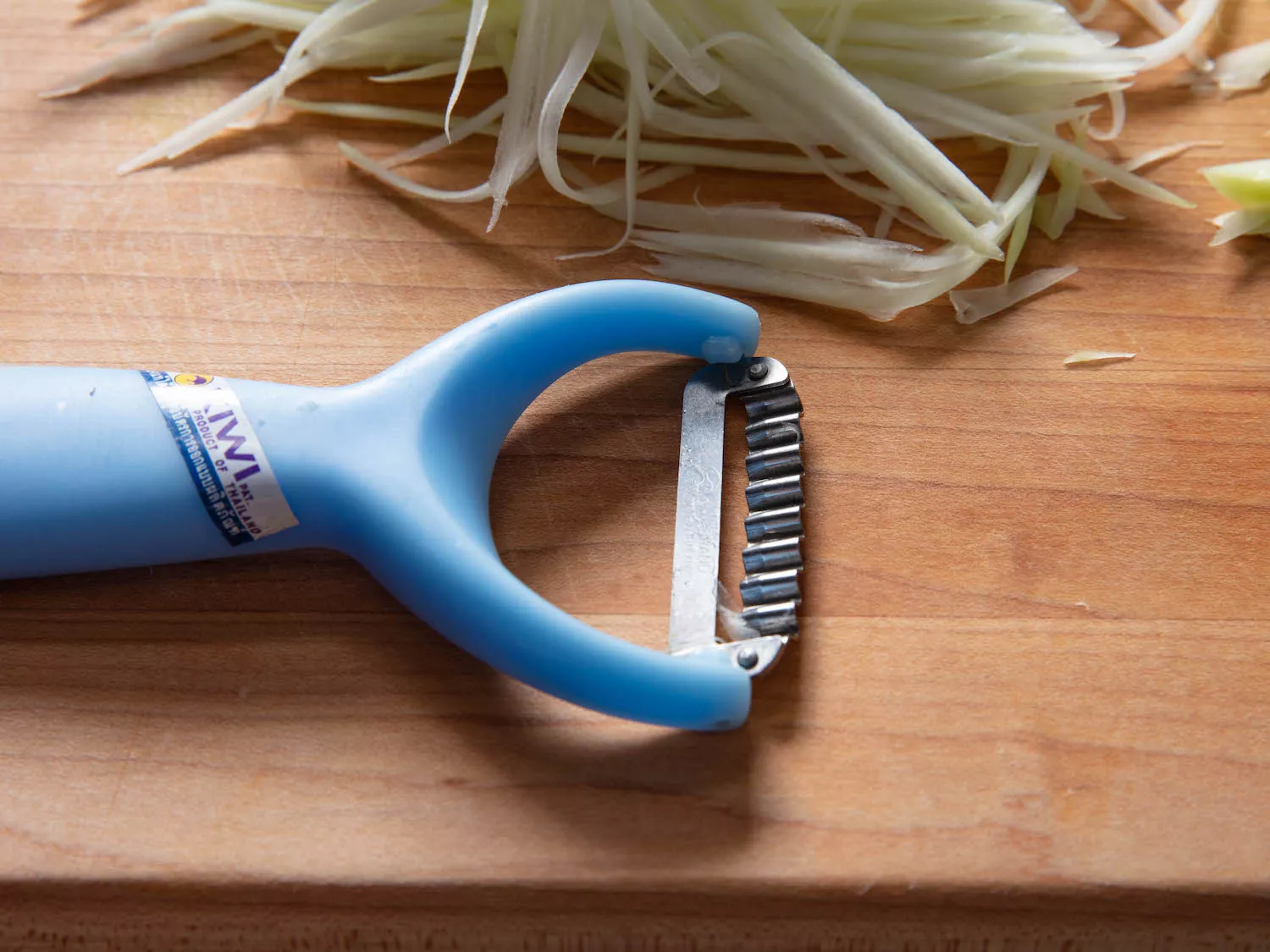 Kiwi brand papaya shredder on a cutting board