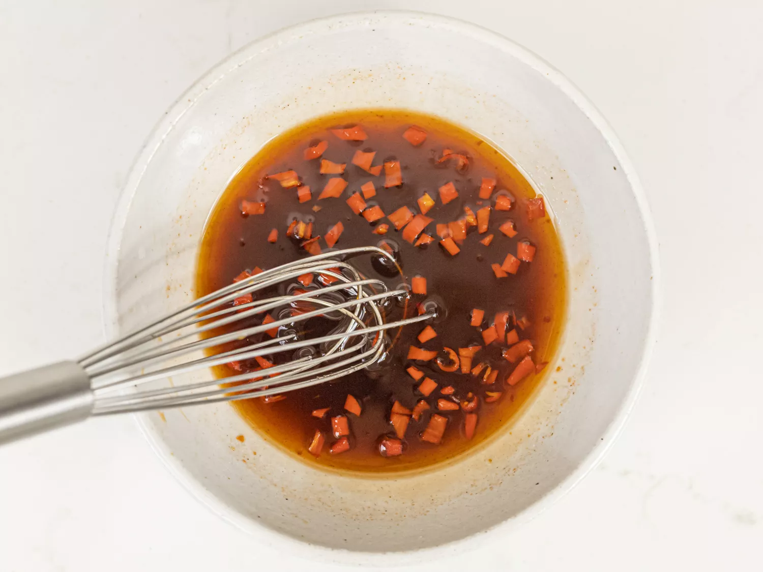 Sugar, vinegar, ketchup, salt, and chiles whisked together in a small bowl